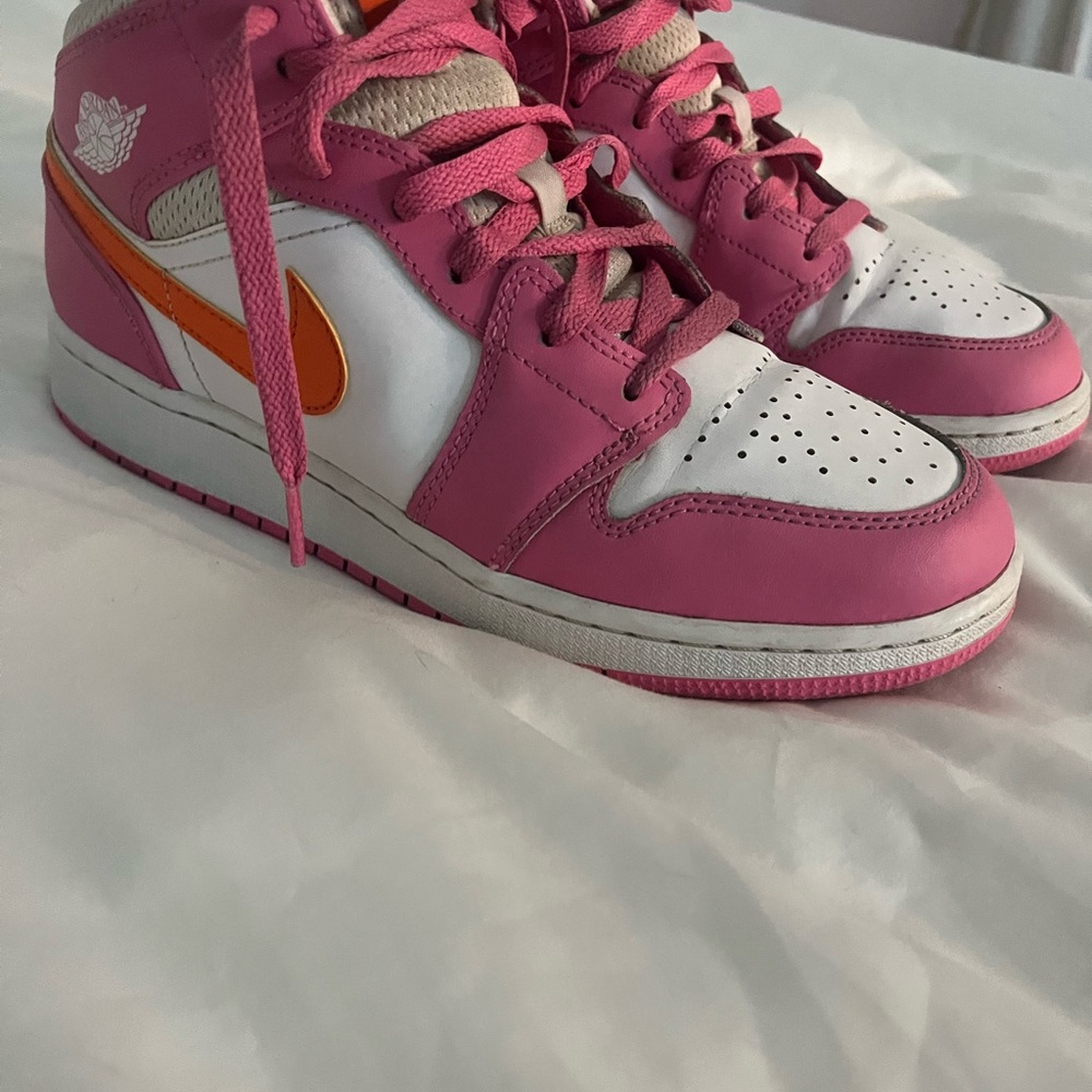 Pink, orange, and white Nike Jordan’s